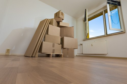 Family moving belongings into household storage in Roehampton