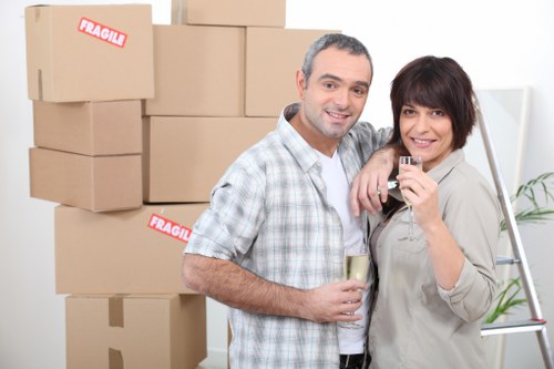 Professional movers handling desks and computers during an office move